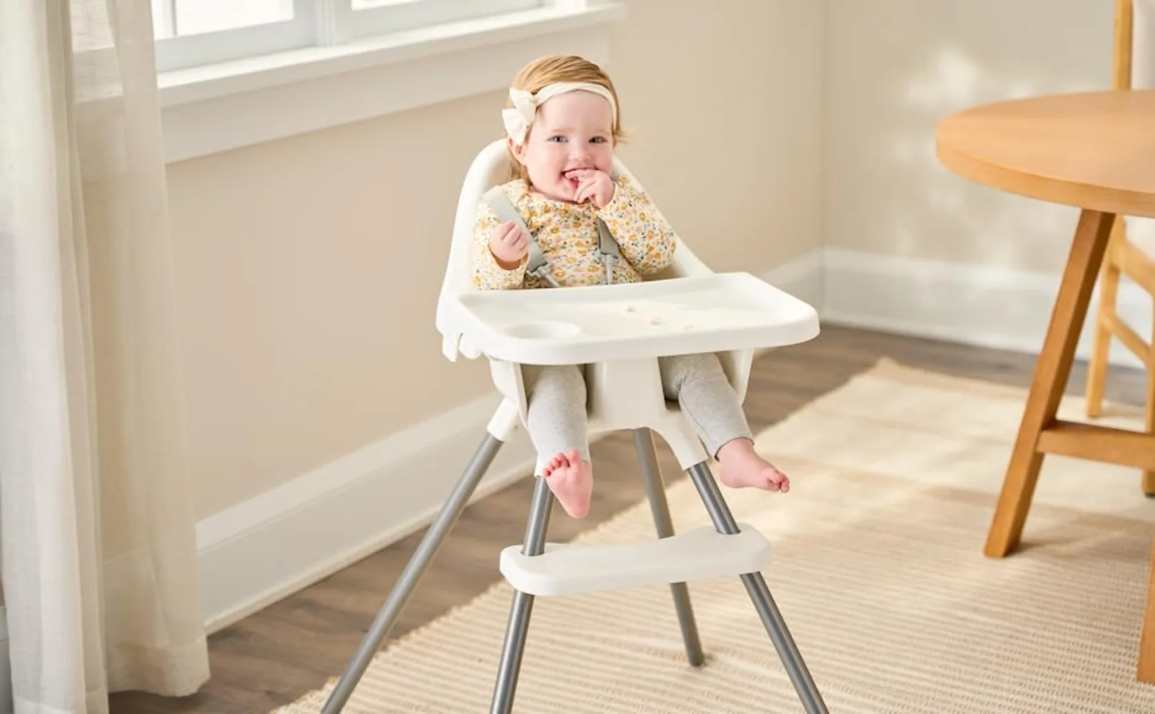 Baby girl seating snack in Regalo Baby Basics High Chair 3600